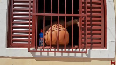 warm dame is caught cleaning the window bare